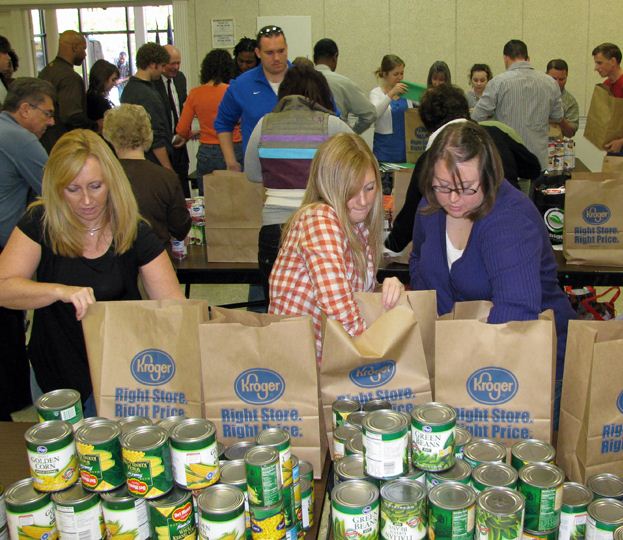 group putting cans into sacks