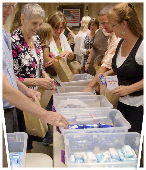 line of people putting items into bags